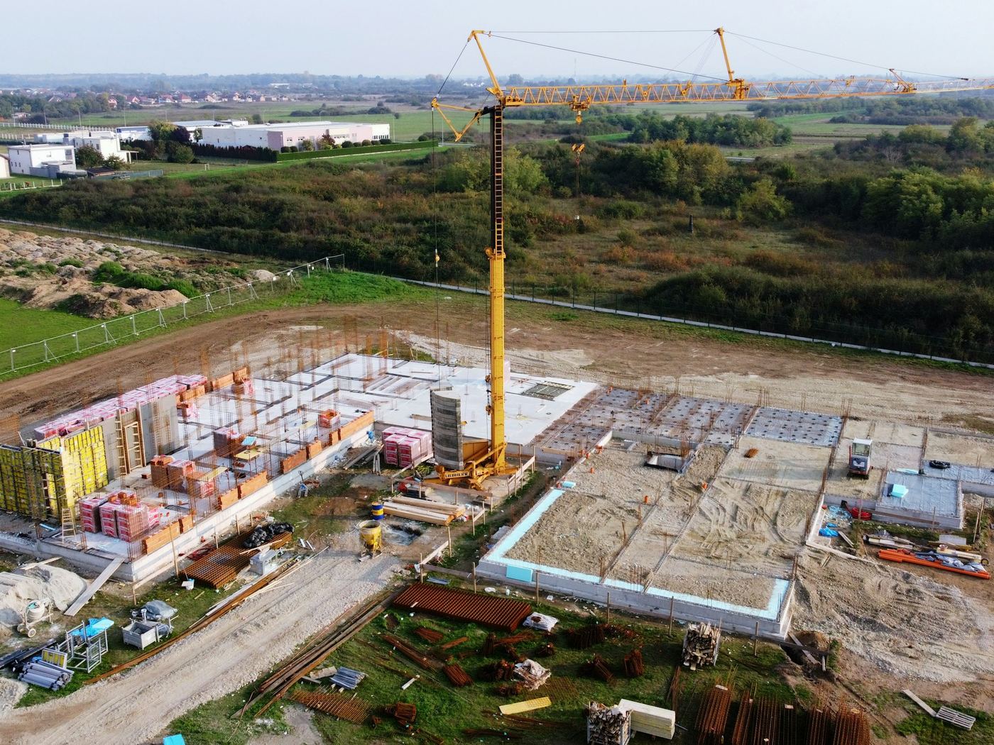 Building site with a tower crane, slab and formwork from the air