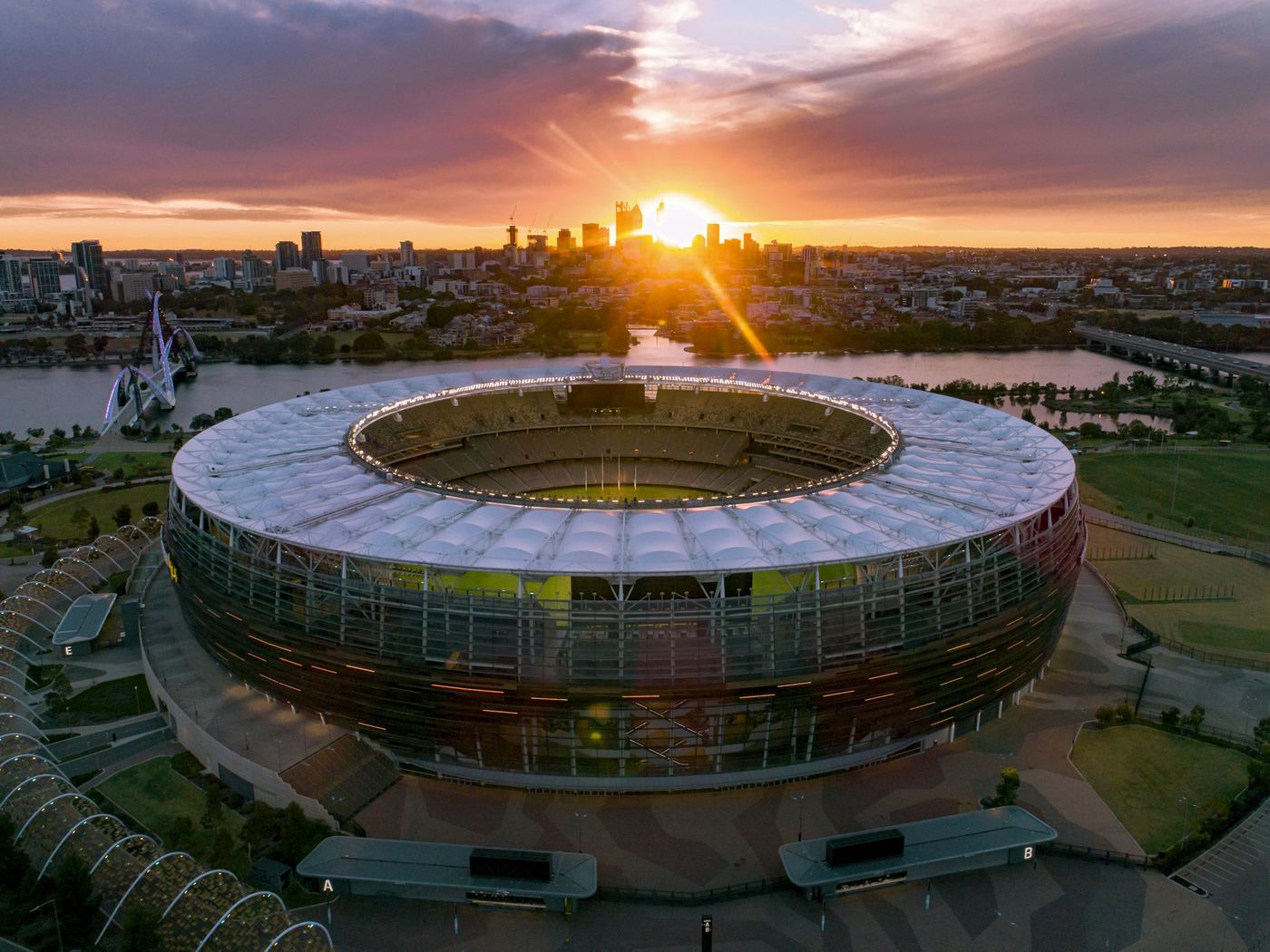 Stadium and river precinct at sunset from a wide aerial position